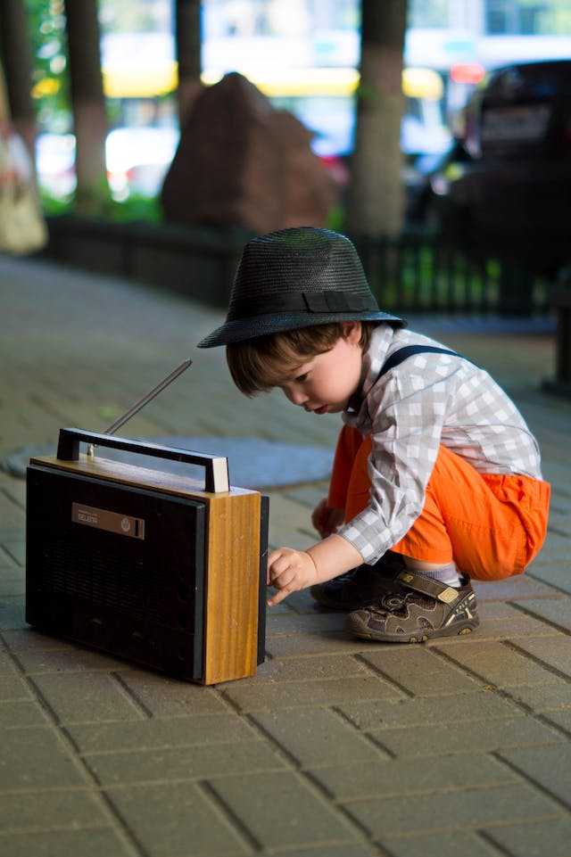 Little boy playing with boom box | Zenified Healing